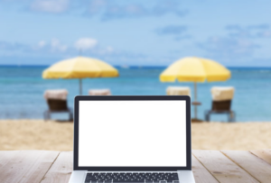 image of a laptop at the beach. Summer Institute 2023 